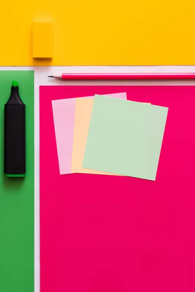 Top view of stationery near paper notes on colorful background — Stock Photo