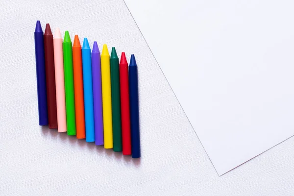 Top view of colorful crayons on white textured background — Stock Photo