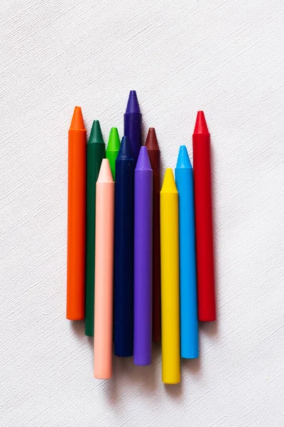 Top view of colorful crayons on textured white background — Stock Photo