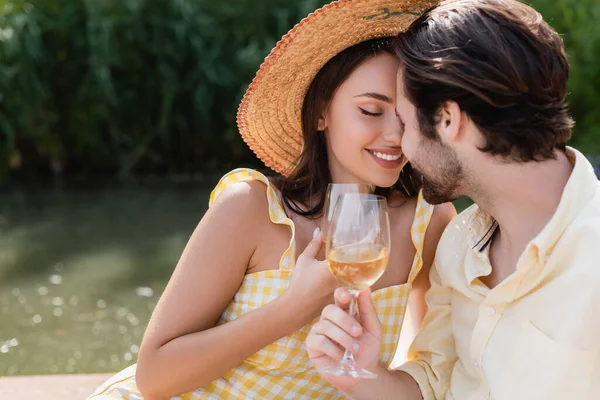 Happy romantic couple holding glasses of wine outdoors — Stock Photo