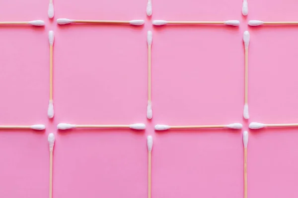 Top view of squares made of cotton swabs on pink background — Stockfoto