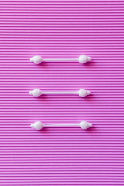 Top view of three cotton swabs on purple textured background — Stockfoto