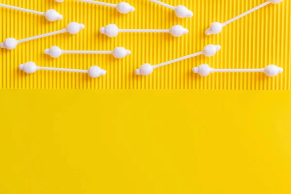 Top view of hygienic cotton swabs on textured and yellow background with copy space — Stockfoto