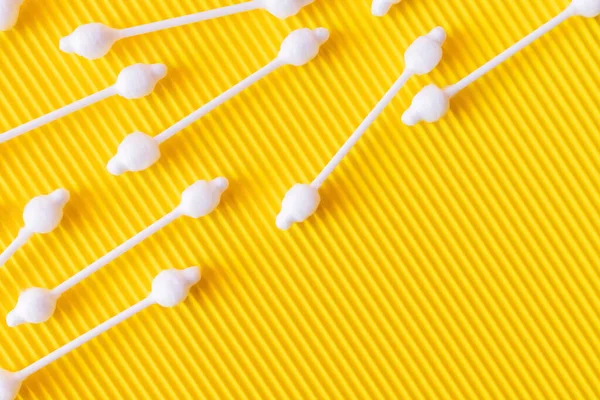 Top view of ear sticks on bright and textured yellow background — Foto stock