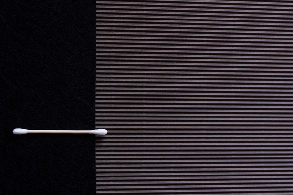 Top view of cotton swab on black and textured background — Fotografia de Stock