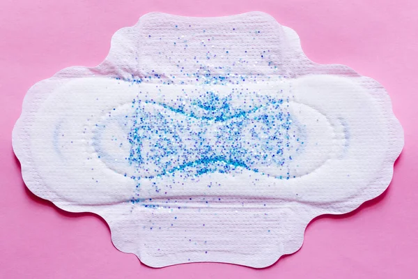 Top view of white panty liner with sequins on violet background — Foto stock
