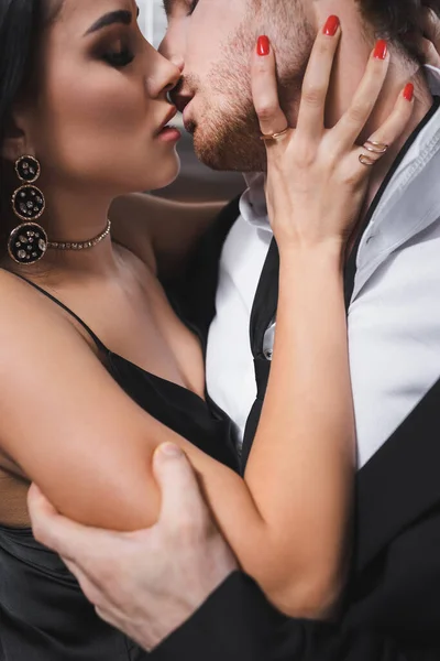 Side view of sexy couple in formal wear kissing in elevator — Stock Photo