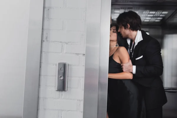 Blurred sexy couple standing in elevator in lobby — Stock Photo