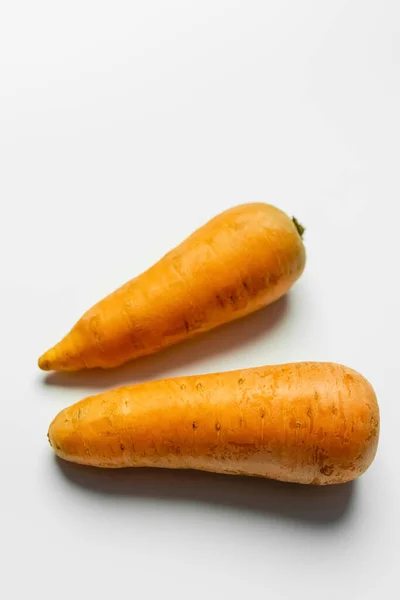 Top view of fresh carrots on white background — Stock Photo
