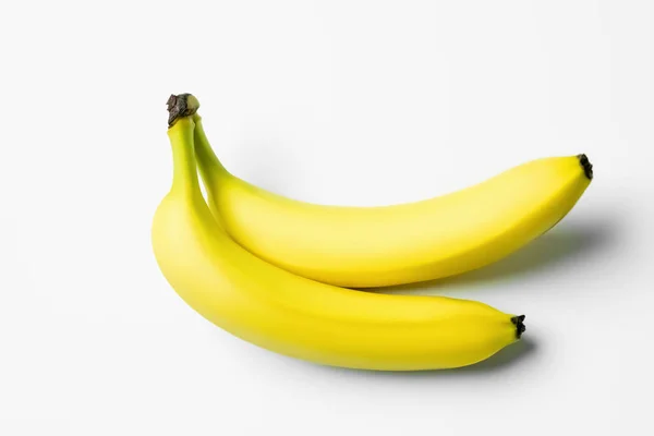 High angle view of ripe bananas on white background — Photo de stock