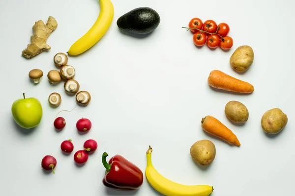 Top view of frame from fresh vegetables and fruits on white background — стоковое фото