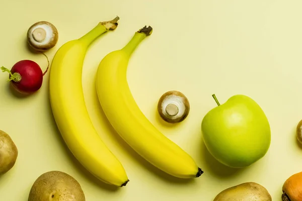 Vue du dessus des fruits et légumes mûrs sur fond jaune — Photo de stock