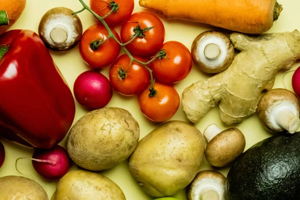 Top view of natural vegetables and avocado on yellow background — Fotografia de Stock