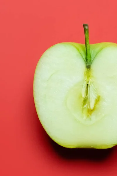 Close up view of cut fresh apple on red background — Stock Photo