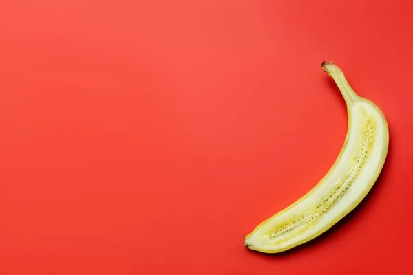 Vue du dessus de la banane coupée sur fond rouge avec espace de copie — Photo de stock