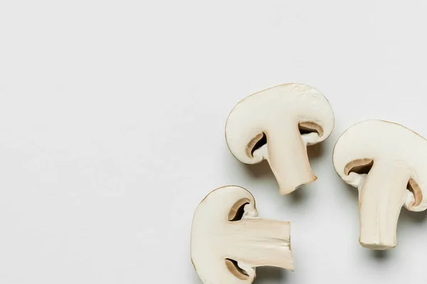 Top view of cut mushrooms on white background with copy space — Fotografia de Stock