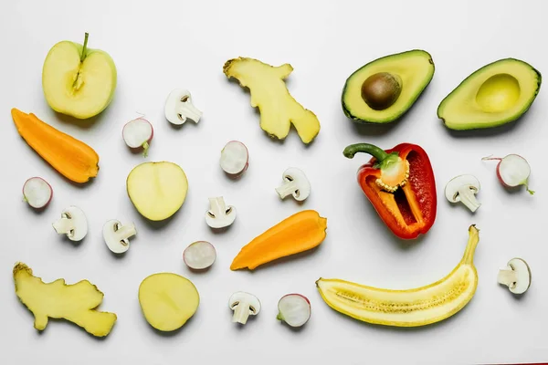 Top view of cut vegetables and fruits on white background — Stock Photo