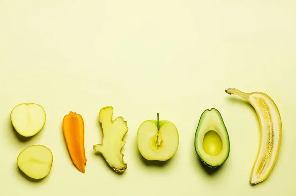 Colocação plana de legumes de corte e frutas no fundo amarelo — Fotografia de Stock