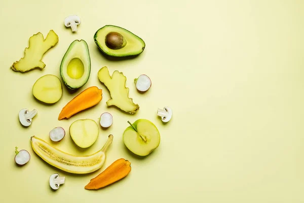 Top view of cut ripe vegetables and fruits on yellow background — Fotografia de Stock