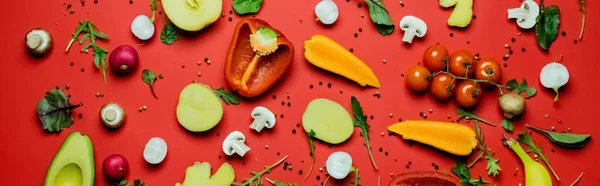 Top view of ripe vegetables, fruits and peppercorns on red background, banner — Foto stock