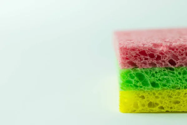 Close up view of colorful porous sponge cloths on grey background - foto de stock