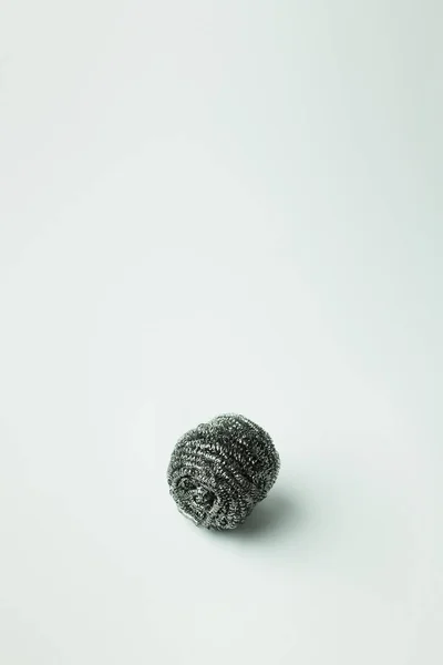 Stainless steel scourer on grey background with copy space — стоковое фото