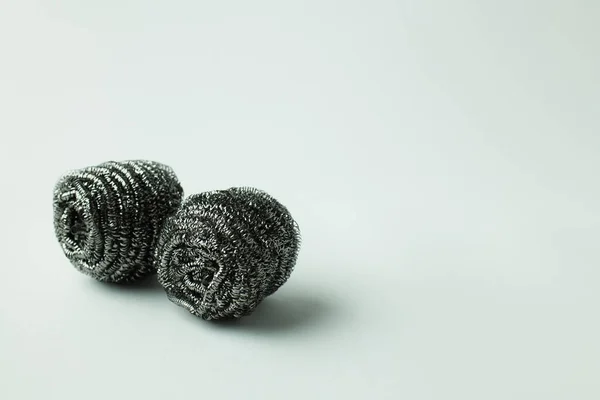 Abrasive steel scourers on grey background with copy space — Stock Photo