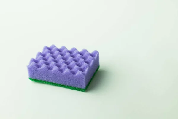 Bright purple textured sponge scourer on grey background — Stock Photo
