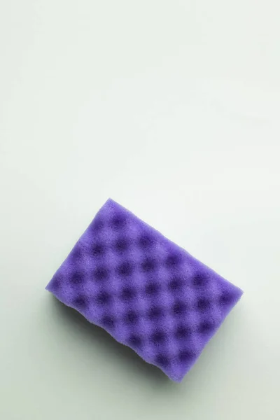 Top view of bright purple sponge on grey background — Stock Photo