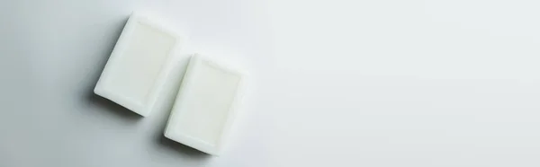 Top view of two soap bars on grey background with copy space, banner — Stockfoto