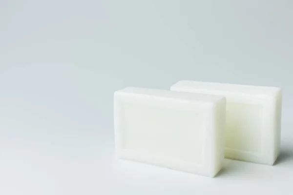 White toilet soap bars on grey background — Photo de stock