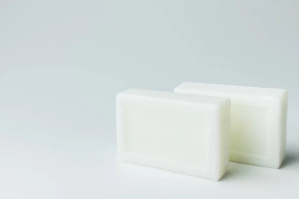 White toilet soap bars on grey background — Stock Photo
