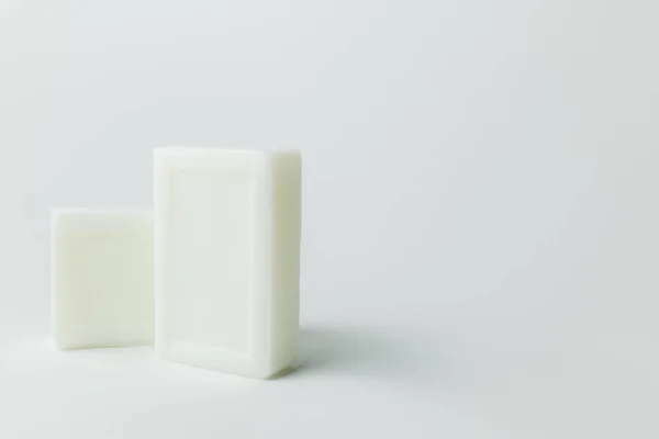 White soap bars on grey background with copy space — стоковое фото