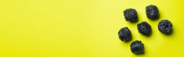 Top view of abrasive wire scourers on yellow background with copy space, banner — Stock Photo
