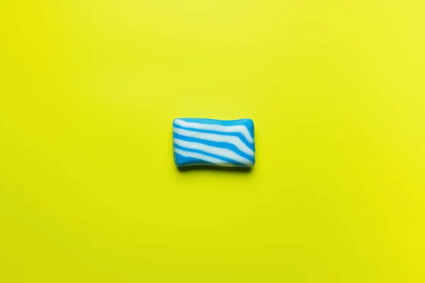 Top view of blue and white soap on yellow background with copy space — стоковое фото