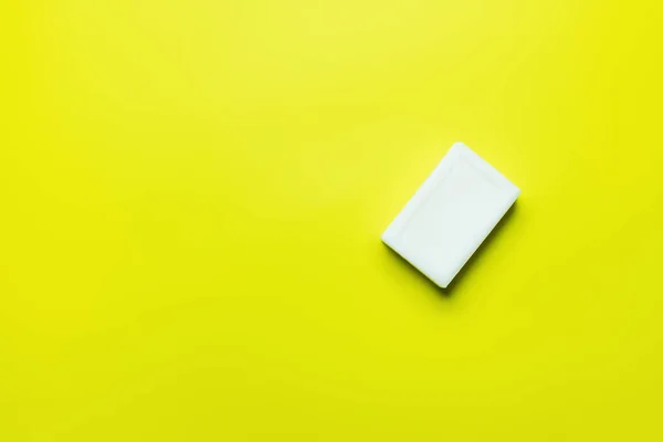 Top view of white soap on yellow background with copy space — Foto stock