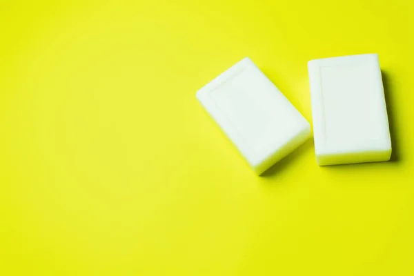 Top view of white toilet soap on yellow background with copy space — Stock Photo