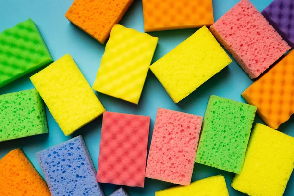 Plenty of multicolored washcloths on blue background, top view — Stockfoto