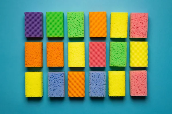 Top view of different colorful kitchen washcloths on blue background — Foto stock