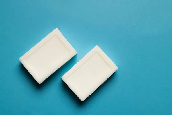 Top view of white toilet soap on blue background — Stockfoto