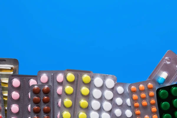 Ansicht von Blisterverpackungen mit verschiedenen Pillen isoliert auf blau — Stockfoto