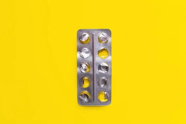 Top view of used blister pack isolated on yellow — Fotografia de Stock