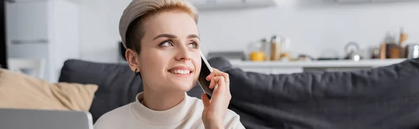 Happy woman talking on mobile phone at home and looking away, banner — Stock Photo