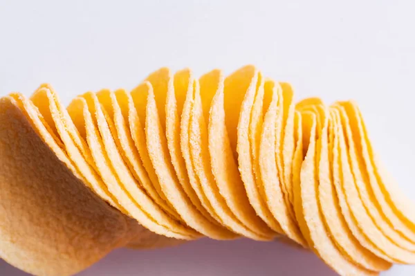 Top view of salty and crispy potato chips on white - foto de stock