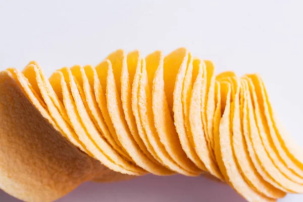 Top view of salty and crispy potato chips on white — Stock Photo