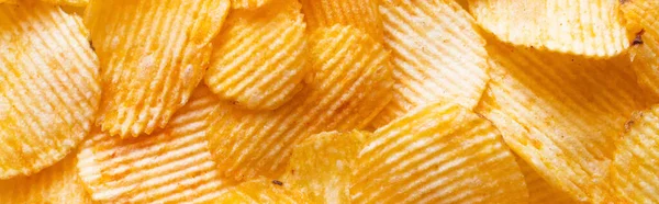 Bunch of wavy and salty potato chips, banner — Stock Photo
