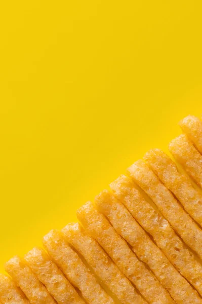 Flat lay of tasty and crispy french fries on yellow — Fotografia de Stock