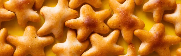 Close up view of tasty cookies in shape of stars on yellow, banner — Stock Photo
