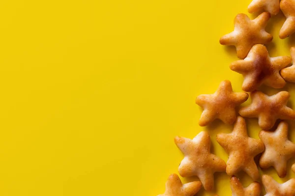 Вид зверху смачне печиво у формі зірок на жовтому — стокове фото