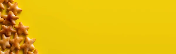 Top view of tasty cookies in shape of stars on yellow, banner — стоковое фото